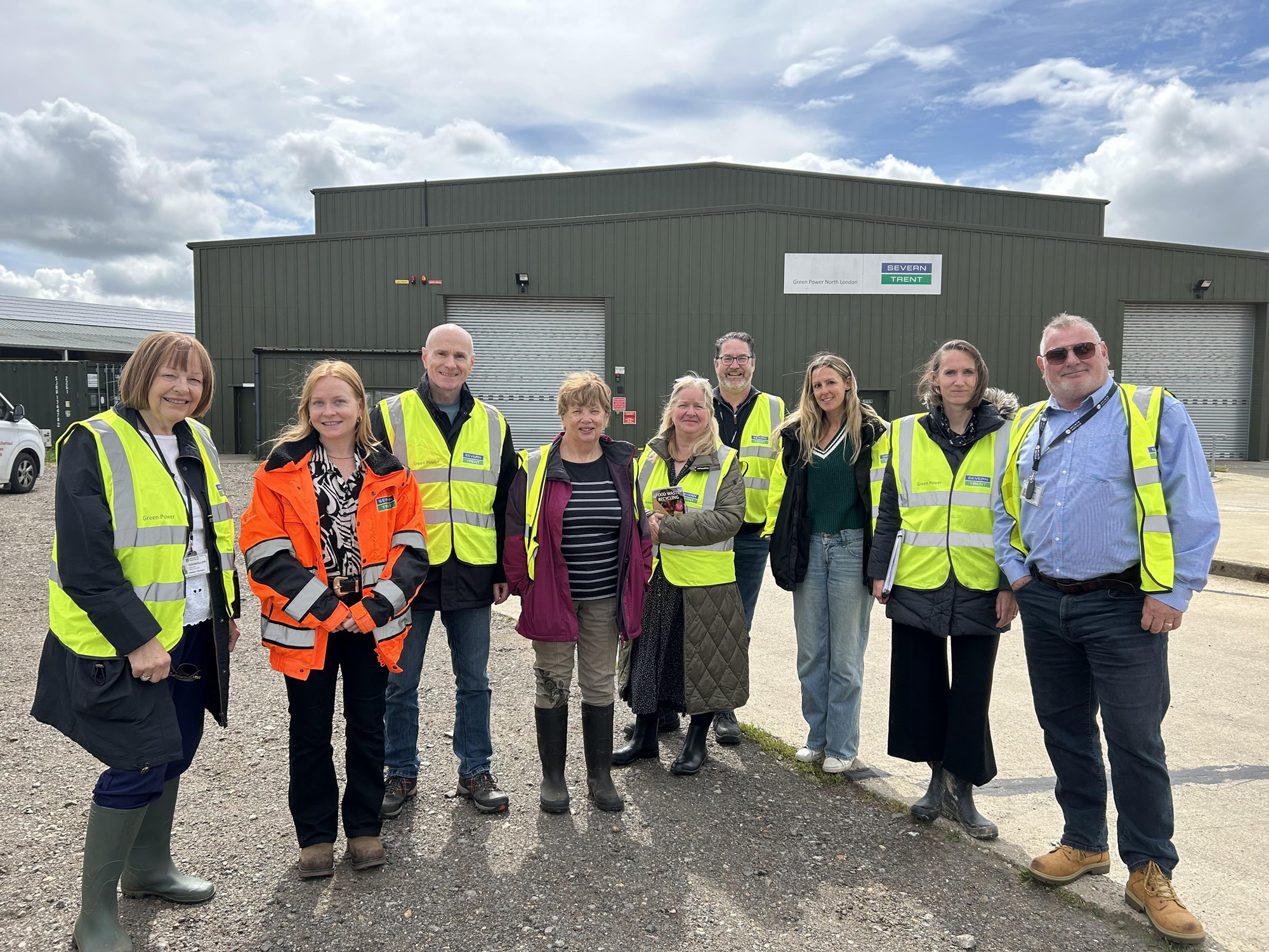 Group of Councillors and council officers stnading outside a large warehouse