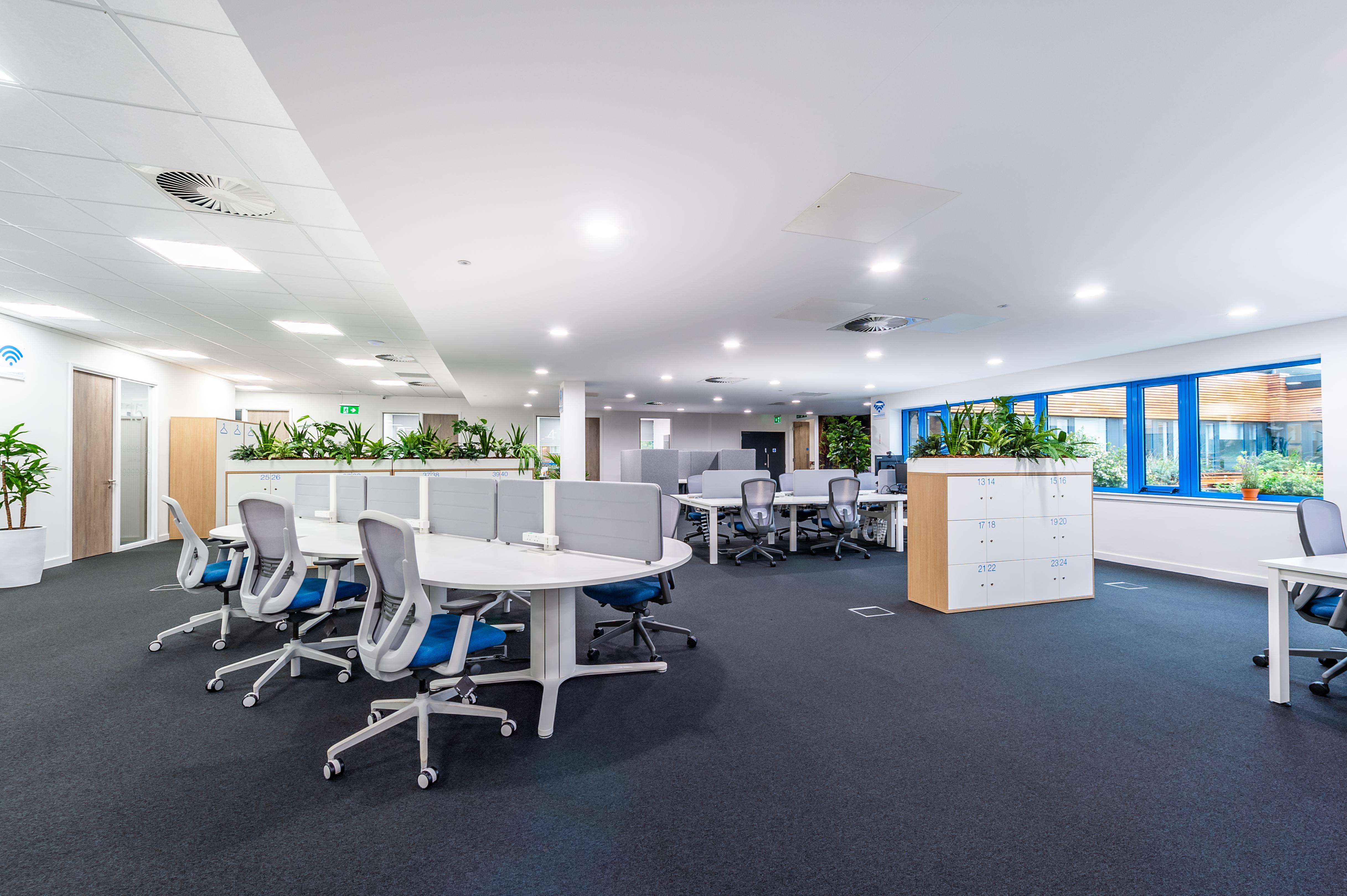 Inside of the HatTech office where there are office chairs and lockers