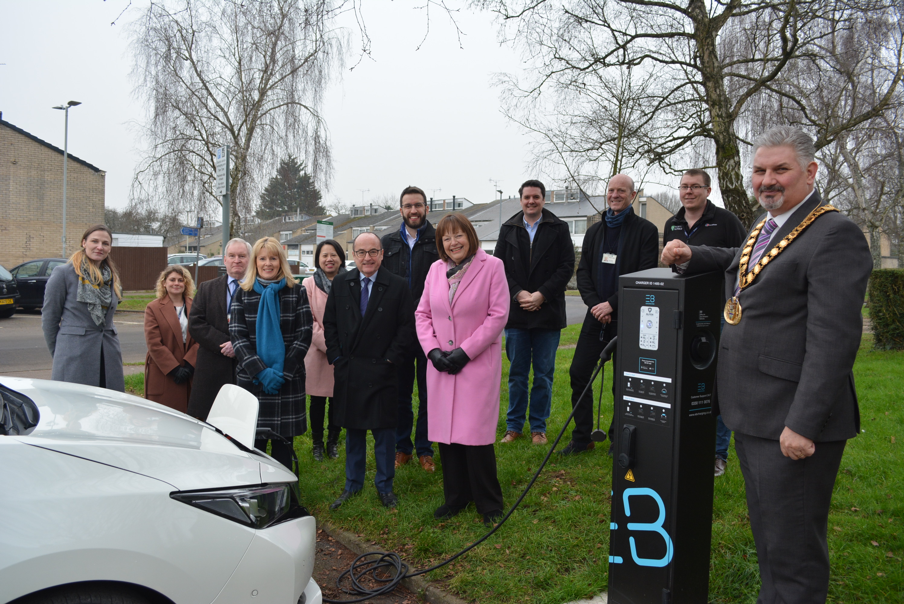 Chief exec Ka, the Mayor, councillors, council officers and representatives from EB Charging standing next to new charging point.