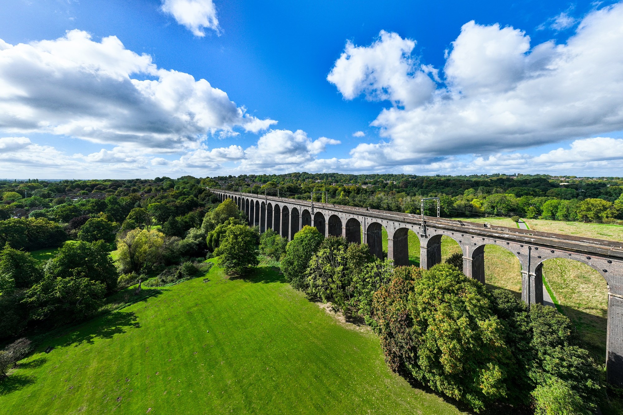 Digswell viaduct/bridge in the middle of a green field, surrounded by trees
