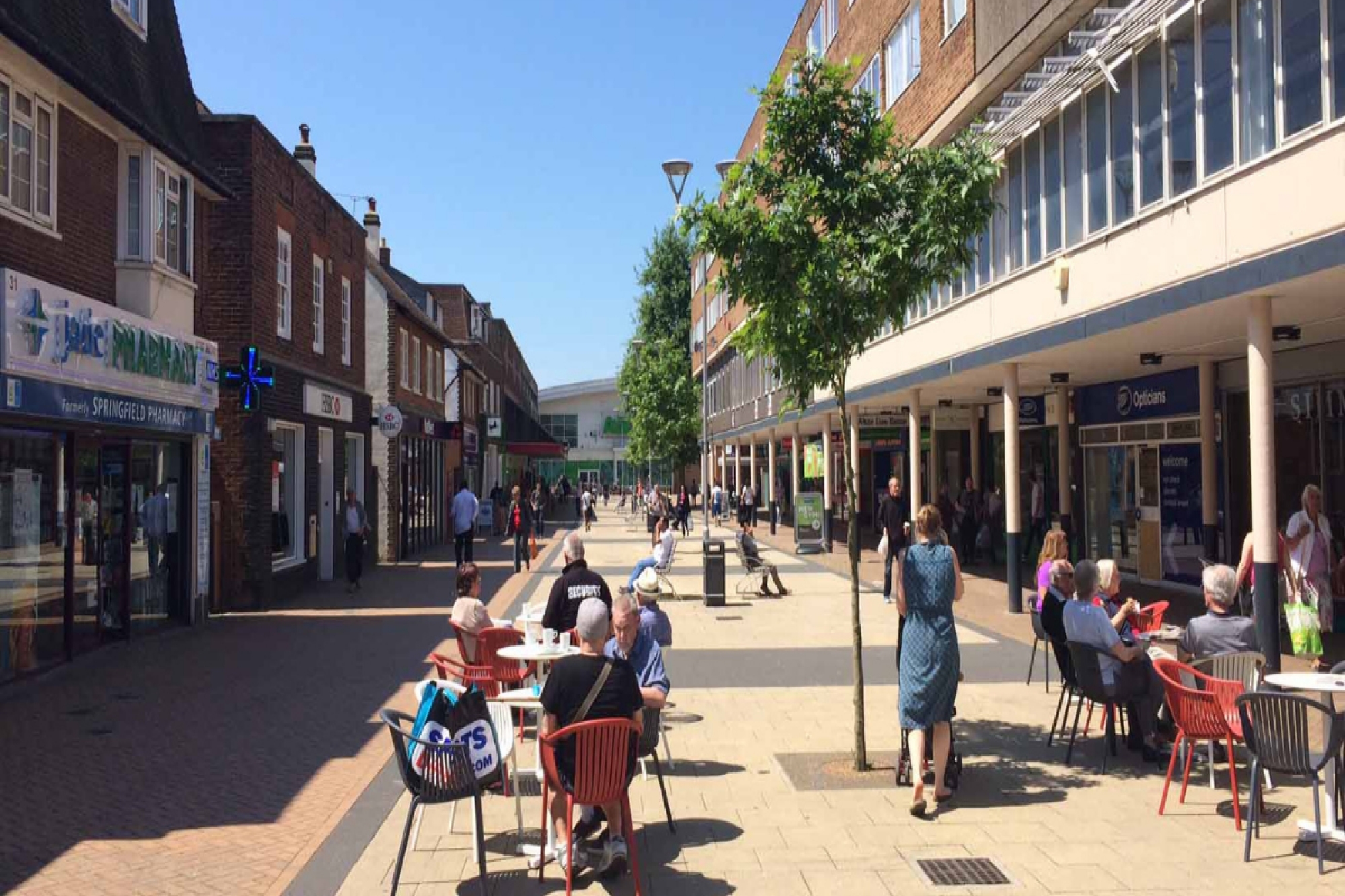 Hatfield White Lion Square. Shops with people sitting outside cafes.