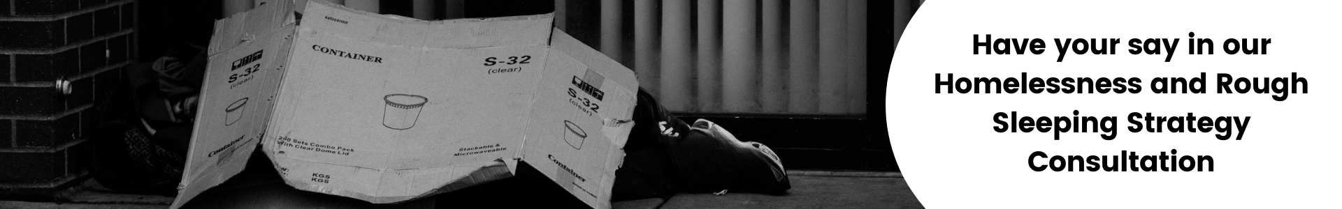 Rough sleeper under cardboard