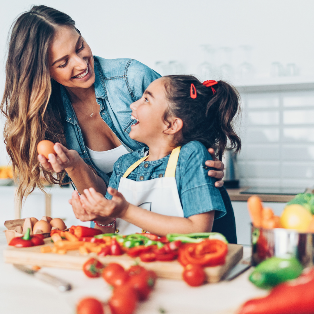 a mother and daughter cooking a healthy meal together